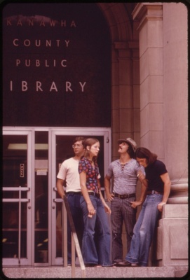 People wearing bell bottom pants at steps of public library on Capitol Street Charleston
