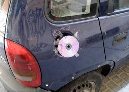 CD taped on car to replace missing gas cap