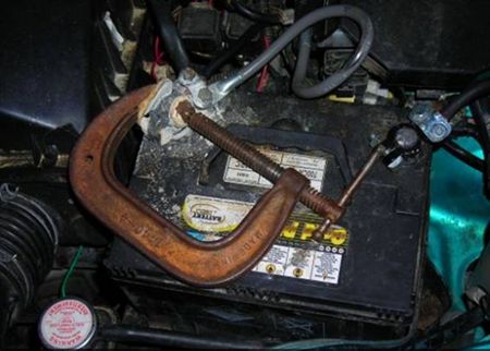 Giant C-Clamp used to hold cable on car battery