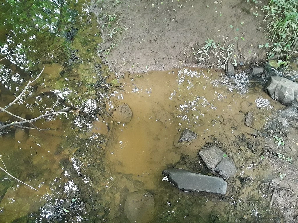 Dirty muddy runoff water in a creek