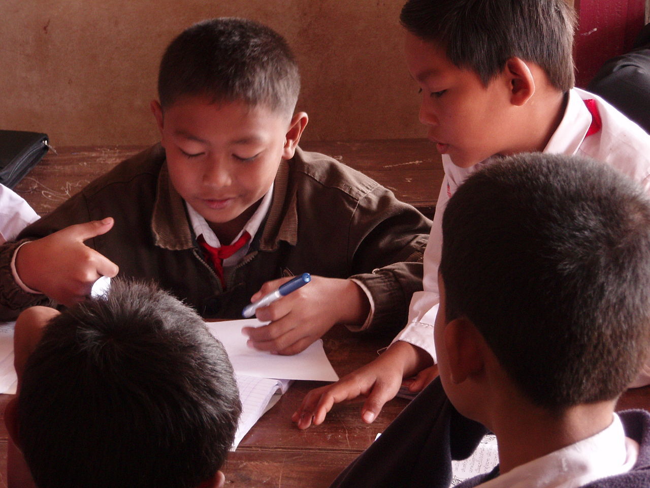 Primary child students pupils in group work in a small village school