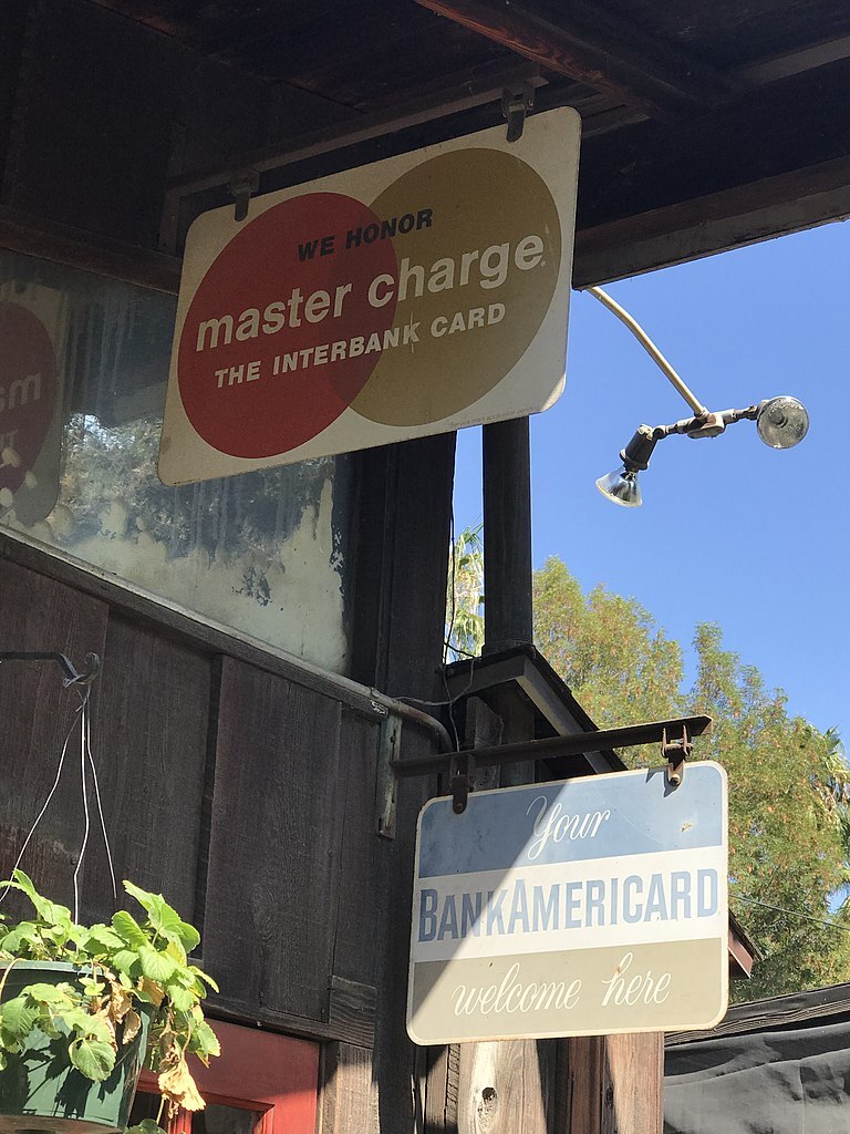 Vintage tin signs advertising early charge card options