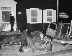 Police remove bodies from the Amityville Horror house