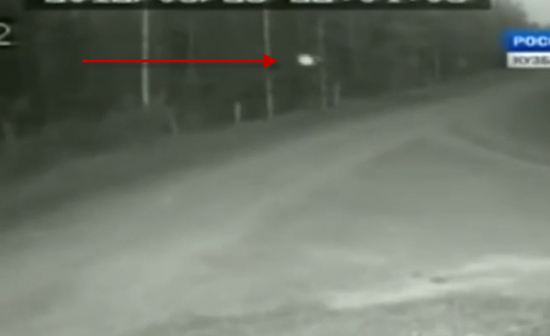 White orb-like ufo caught on cctv camera whizzing down darkened road in russia. 1 White orb UFO caught travelling down darkened road in Russia