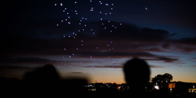 Drone swarm of lights at night