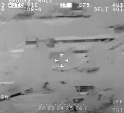 The aircraft's infrared camera tracks the object as it flies low to the ground