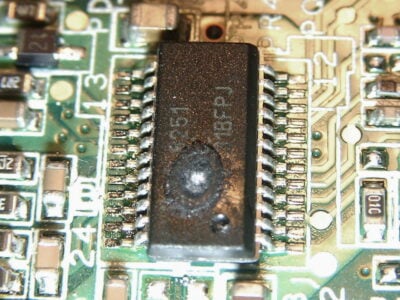Voltage with wrong polarity has caused massive overheating of the chip, consequently melting the plastic casing.