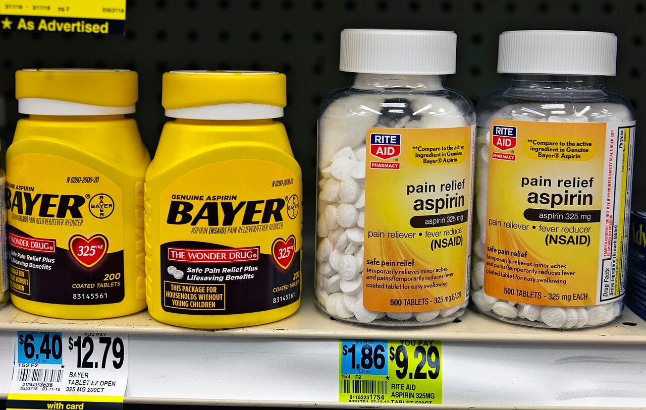 Bottles of Aspirin, made by Bayer and Rite Aid, side-by-side on a store shelf in Montgomery, NY, USA. Both manufacturers may use the brand name generically since aspirin is not a protected trademark in the U.S.