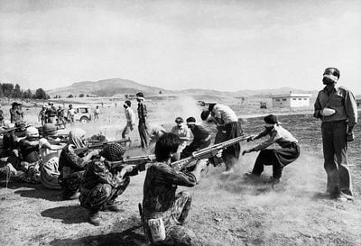 A revolutionary firing squad at the Sanandaj airport in Iran. In a 30-minute trial, 11 prisoners from the Kurdish rebellion were charged with crimes of firearm trafficking, murder, and inciting riots, and were sentenced to death. The men were blindfolded and led outside to the airfield, where they were lined up several meters from their executioners. Razmi was unhindered by security forces, allowing him to stand behind the rightmost executioner and photograph the killings. The weapons are Heckler & Koch G3
