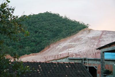 Deforestation in Atlantic Forest Rio de Janeiro - Brazil. This hill was deforestated in order to use its clay in civil construction in Barra da Tijuca. Many trucks with the city public service logo worked on the hill destruction.