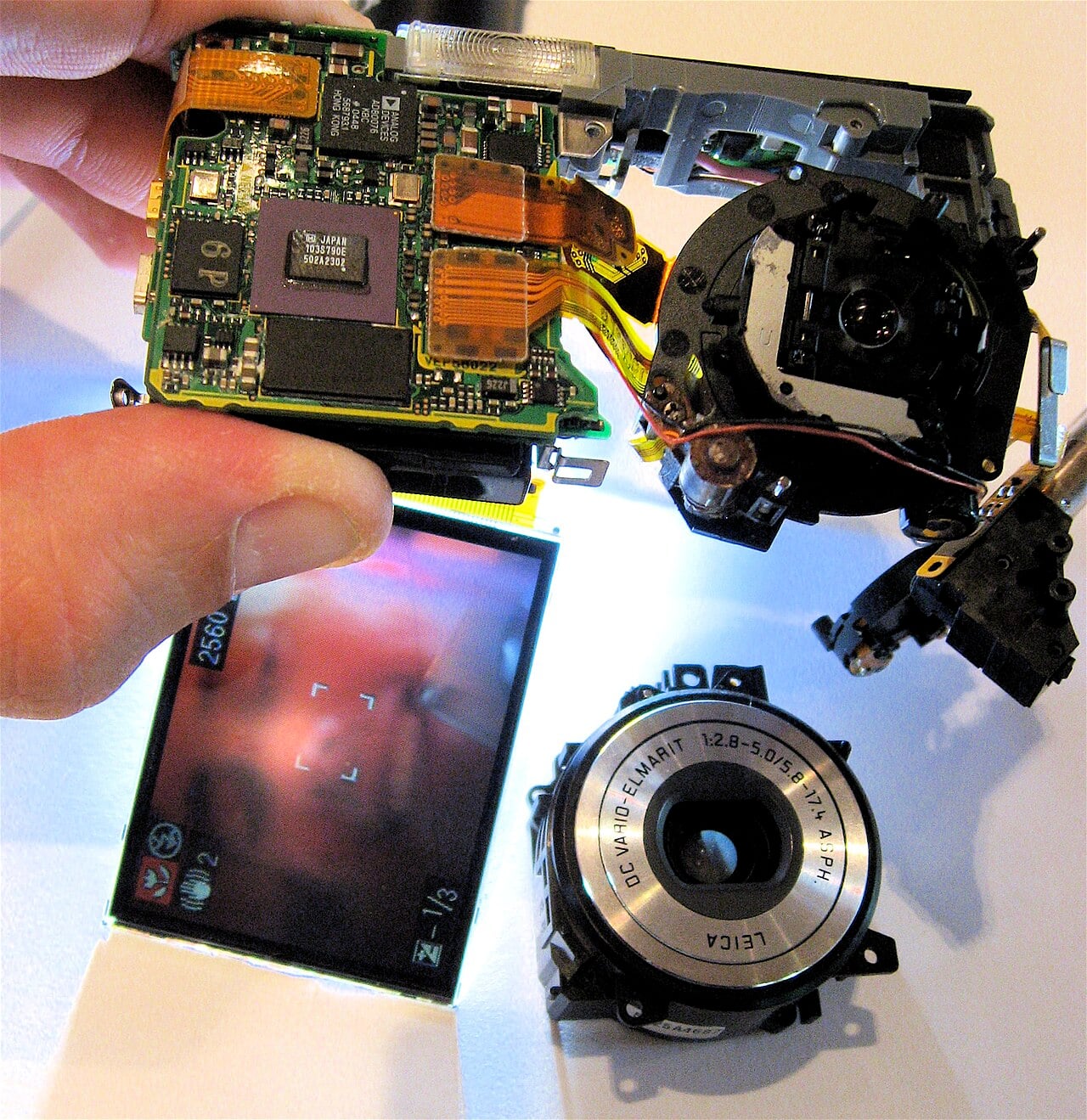 A partly disassembled Panasonic Lumix digital camera, with the front lens removed, but still functioning