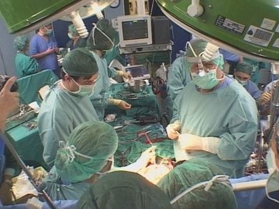 Doctors performing surgery on a patient