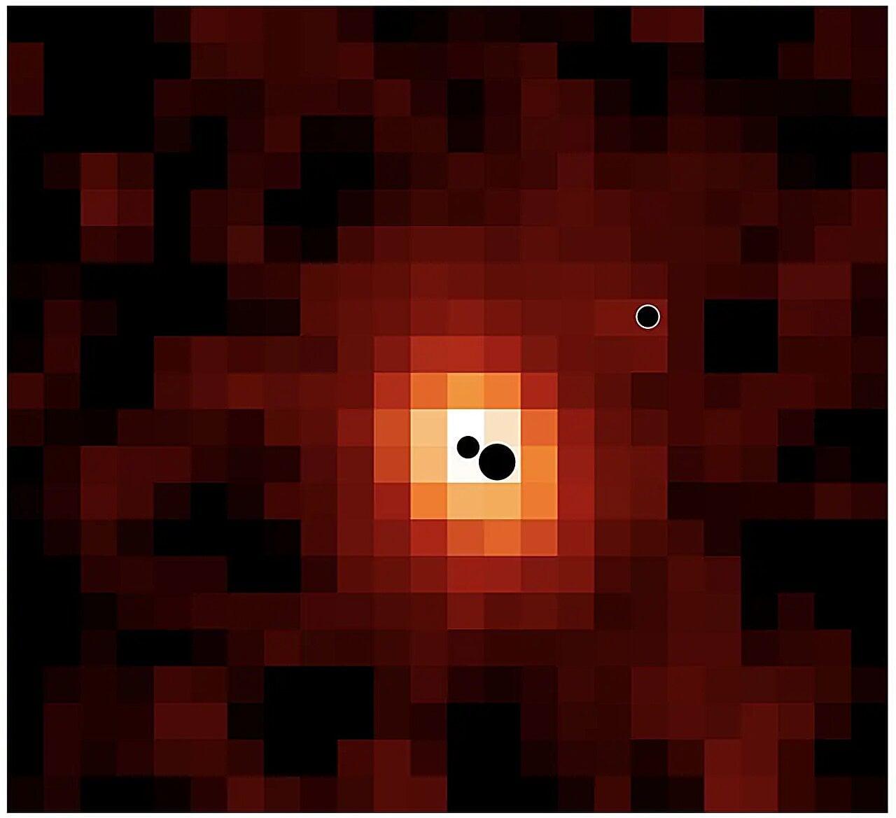 Map of the distant galaxy J0148-4214 in ionised hydrogen (Hα). The locations of the three massive black holes are indicated by black circles (not to scale). The most massive and least massive black holes are located in the galaxy centre; a third black hole is located in the galaxy outskirts. Credit: Hannah Übler